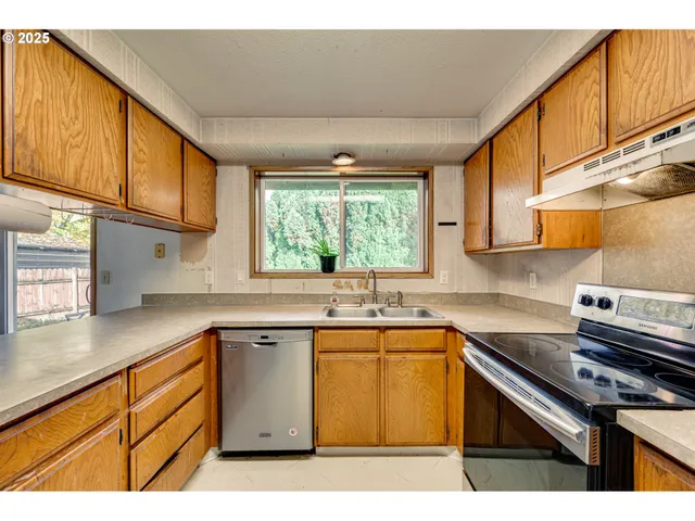 a kitchen with stainless steel appliances a table and chairs