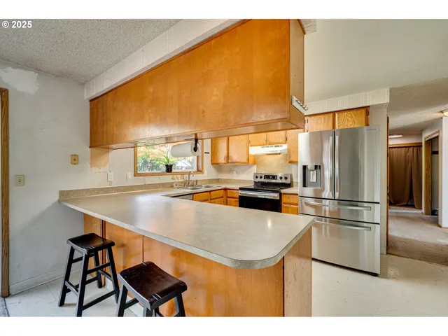 a kitchen with a sink and large window