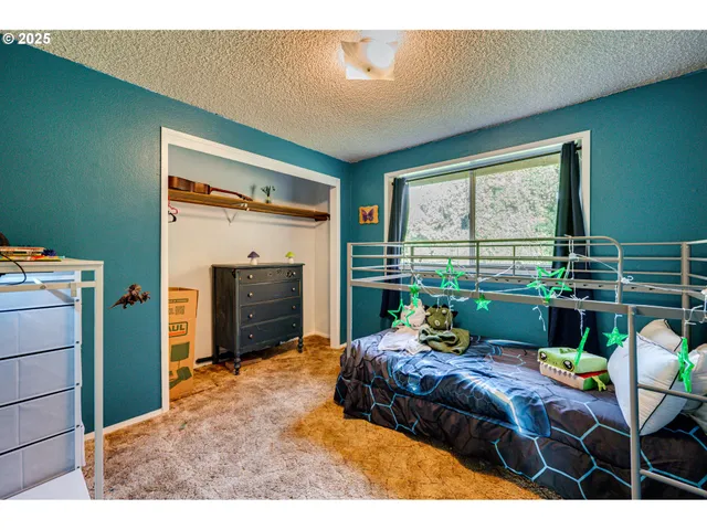 a bedroom with a bed window and wall painting