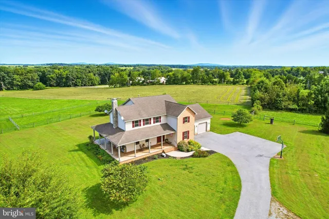 a front view of a house with a yard table and chairs