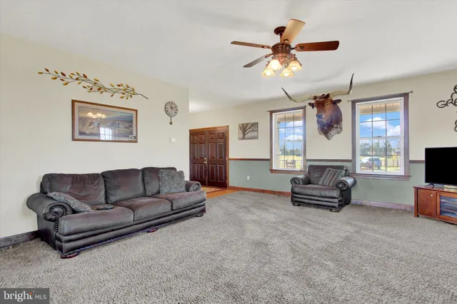 a view of a dining room with furniture and a chandelier