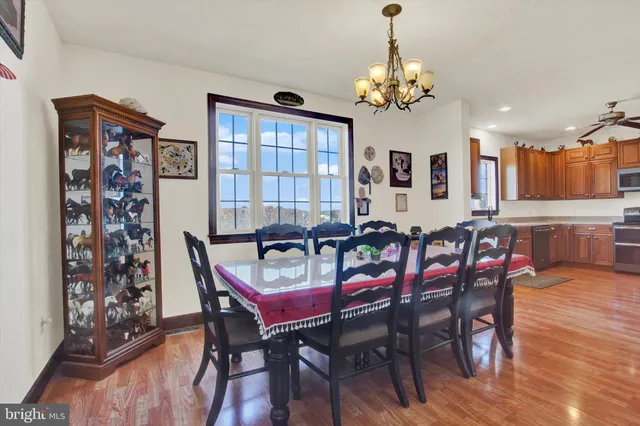 a kitchen with granite countertop a refrigerator cabinets and wooden floor