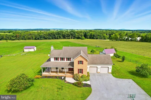 an aerial view of a house with big yard