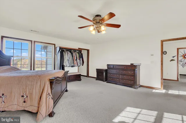 a living room with furniture a flat screen tv and kitchen view