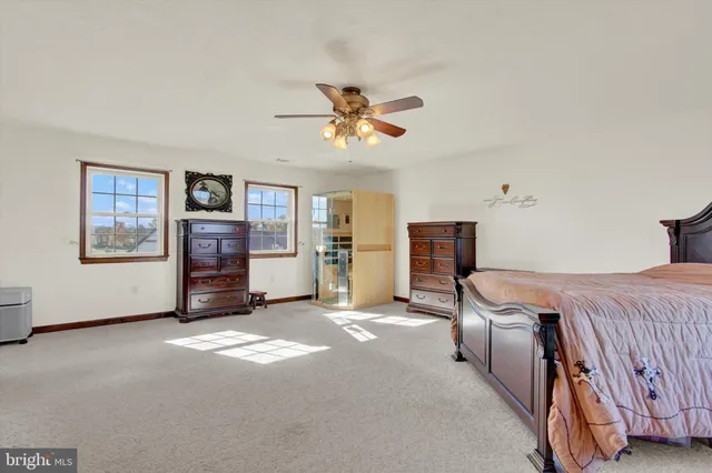 a room with furniture pool table flat screen tv and windows