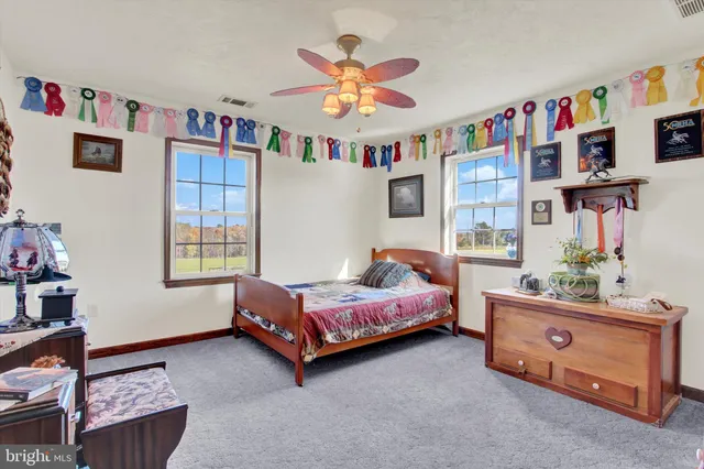 an aerial view of a house with swimming pool a yard and outdoor seating