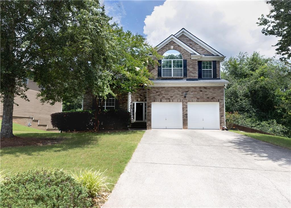 502 Streamside Place Canton, GA 30115 - Photo 1 of 33 a front view of a house with yard and green space