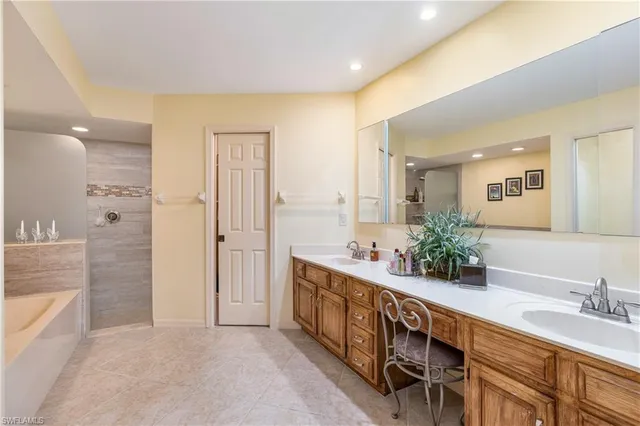 a spacious bathroom with double vanity and a mirror