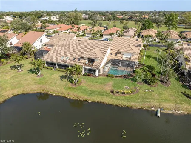 an aerial view of residential houses with outdoor space and ocean view