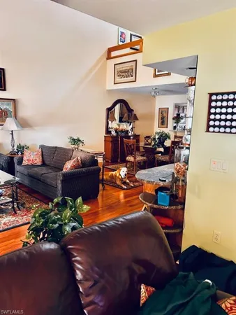 a living room with furniture bookshelf and a window