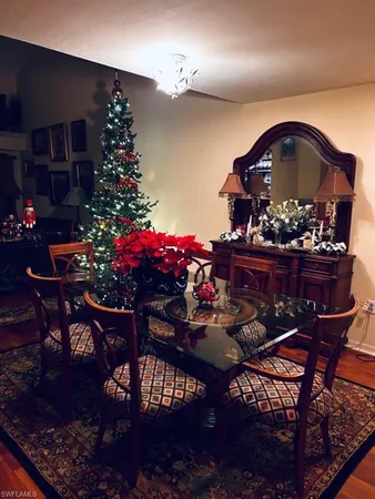a living room with furniture floor to ceiling window and a wooden floor