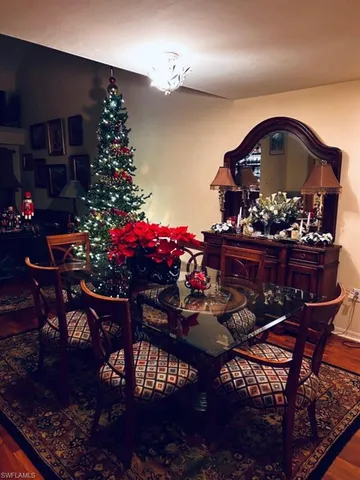 a living room with furniture floor to ceiling window and a wooden floor