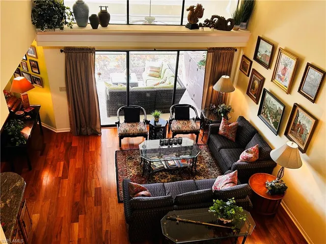 a living room filled with furniture and a floor to ceiling window