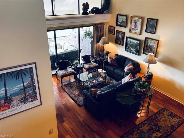 a living room with furniture and a floor to ceiling window