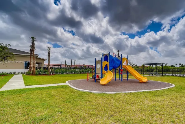 a view of outdoor space with playground and green space