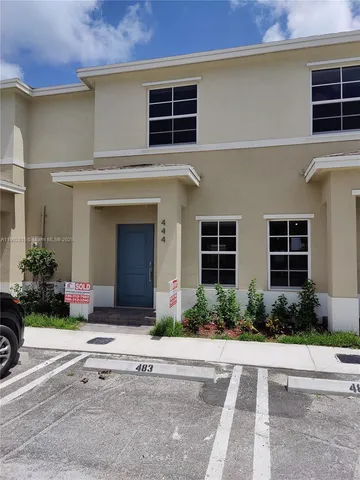 a front view of a house with a yard and a garage