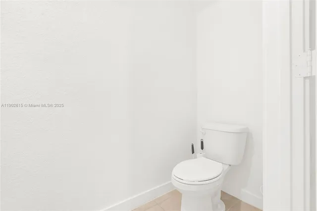 a white toilet sitting next to a white sink