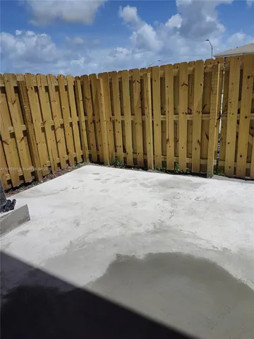 a view of a blue door with wooden fence