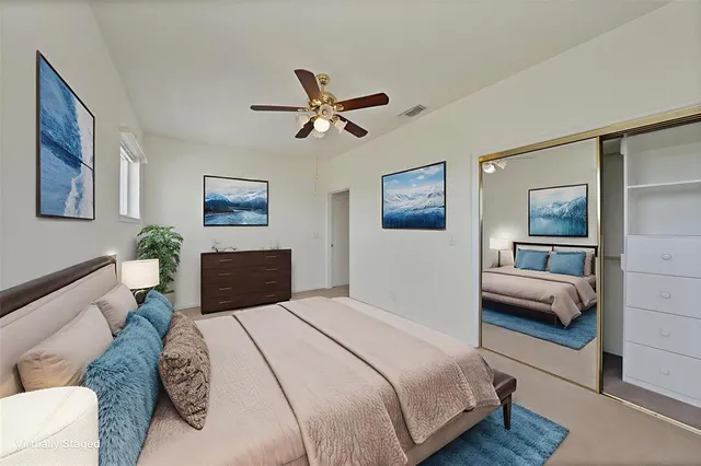 a bedroom with a bed a couch and a view of bathroom