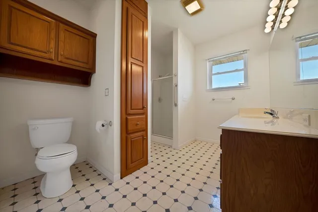 a bathroom with a sink a toilet and a mirror
