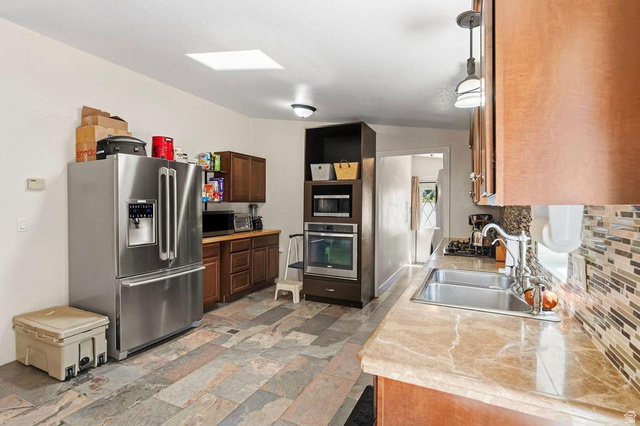 327 North Lodge Road Central, UT 84722 - Photo 10 of 45 Kitchen featuring stone-finish flooring and a skylight