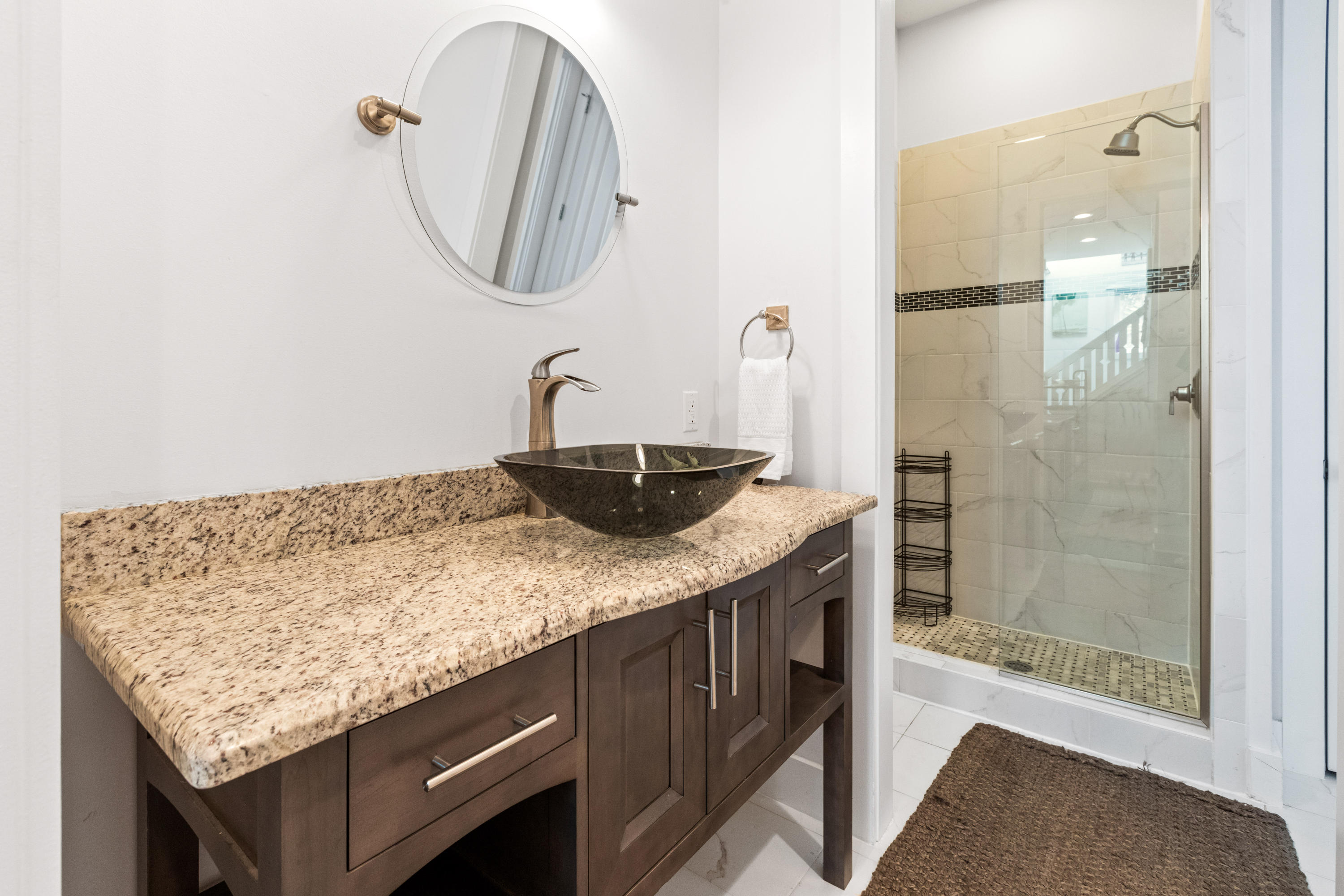 18 Hiker Street Santa Rosa Beach, FL 32459 - Photo 15 of 39 a bathroom with a granite countertop sink a mirror and shower