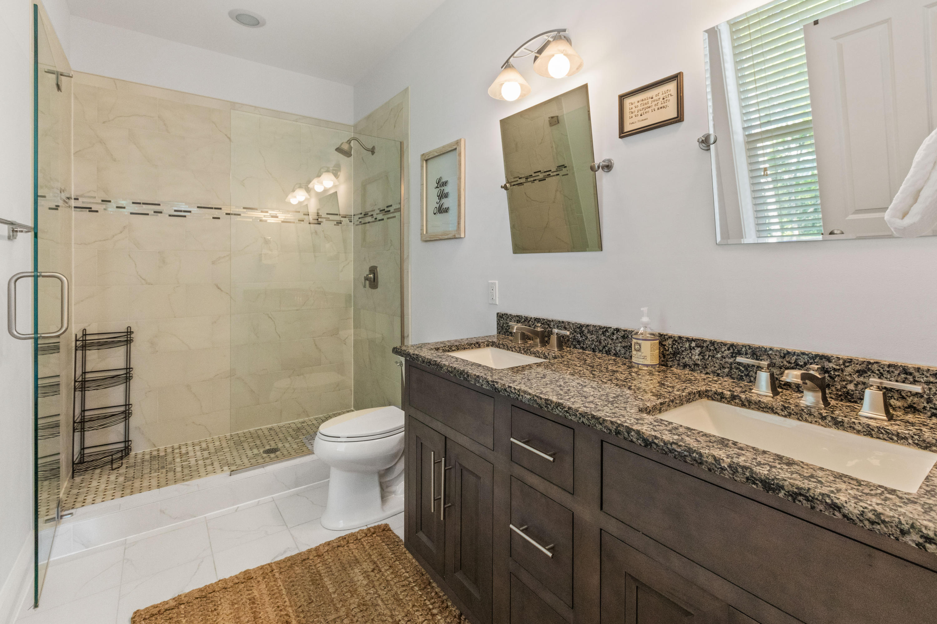 18 Hiker Street Santa Rosa Beach, FL 32459 - Photo 30 of 39 a bathroom with a granite countertop sink a toilet a mirror and shower