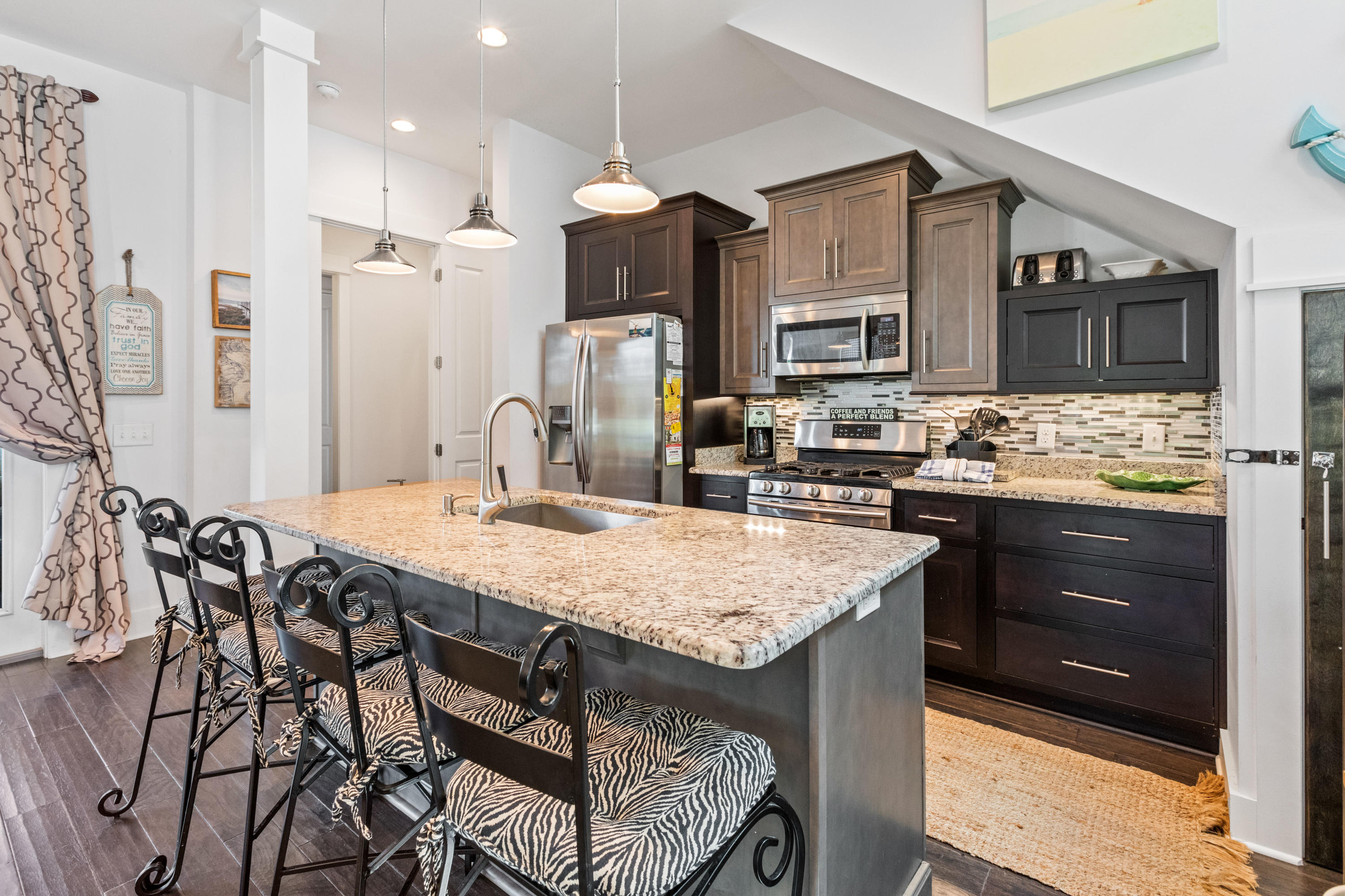 18 Hiker Street Santa Rosa Beach, FL 32459 - Photo 10 of 39 a kitchen with a table chairs refrigerator and cabinets