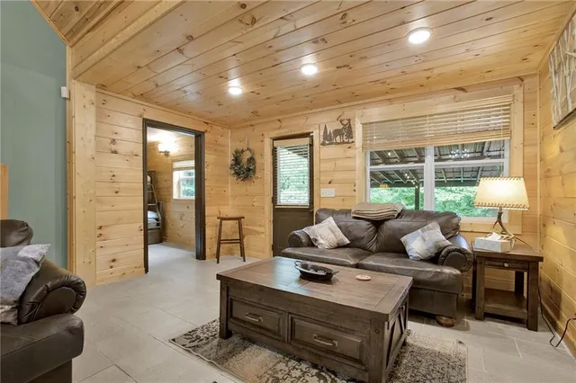 a living room with fireplace furniture and a flat screen tv