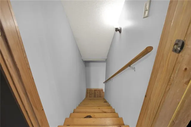 a bedroom with a bed next to a window