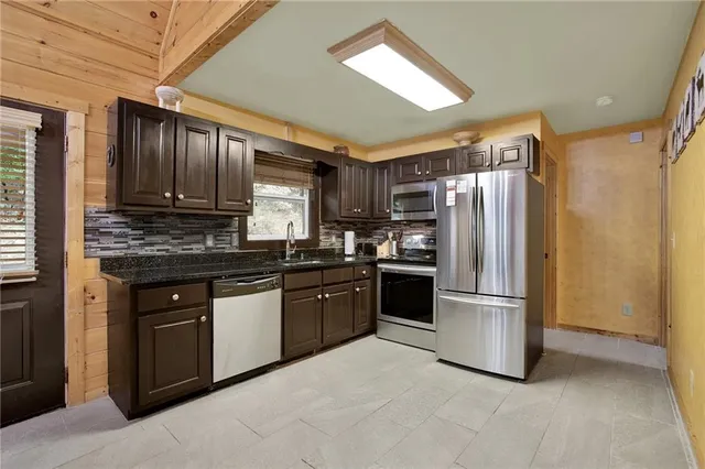 a front view of house with deck and outdoor seating