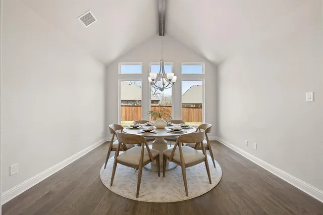 a bedroom with a large bed chandelier and a window