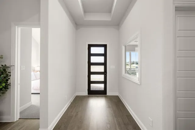 a view of a hallway with wooden floor