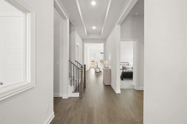 a living room with furniture a fireplace and a chandelier