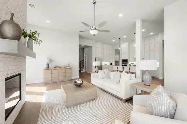 a living room with furniture a large window and a chandelier