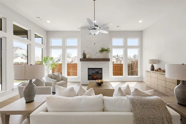 a living room with furniture fireplace and a chandelier