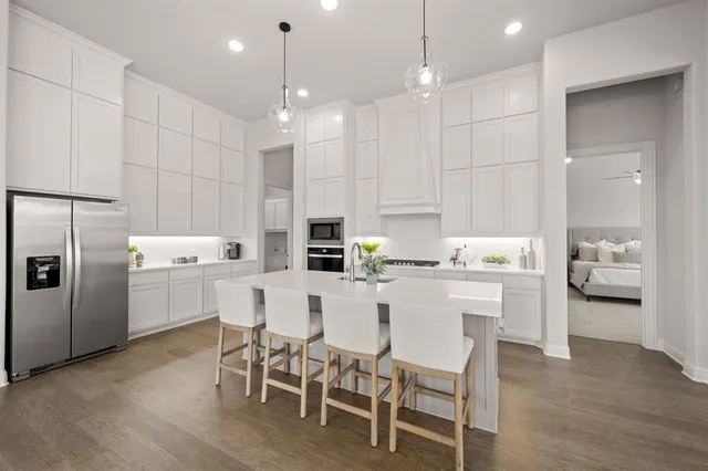 a kitchen with stove a sink and cabinets