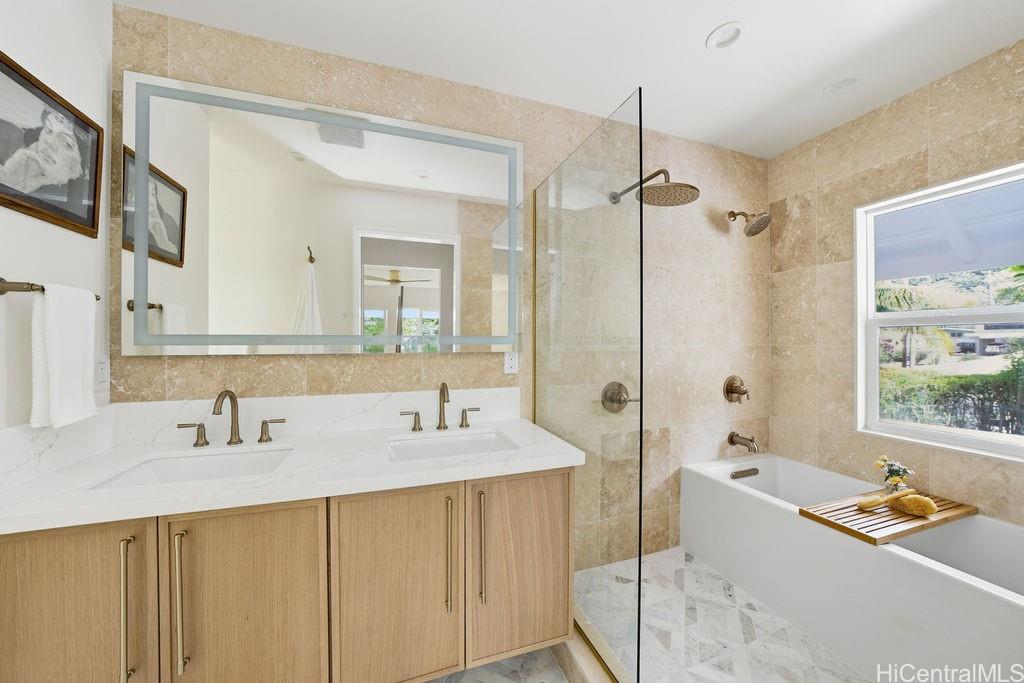3198 Alika Avenue Honolulu, HI 96817 - Photo 17 of 25 a bathroom with a tub sink and mirror