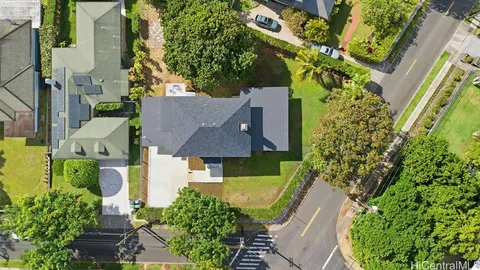 an aerial view of a house with swimming pool and garden