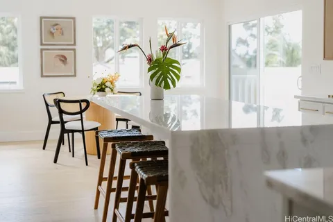 a view of a dining room with furniture and a potted plant