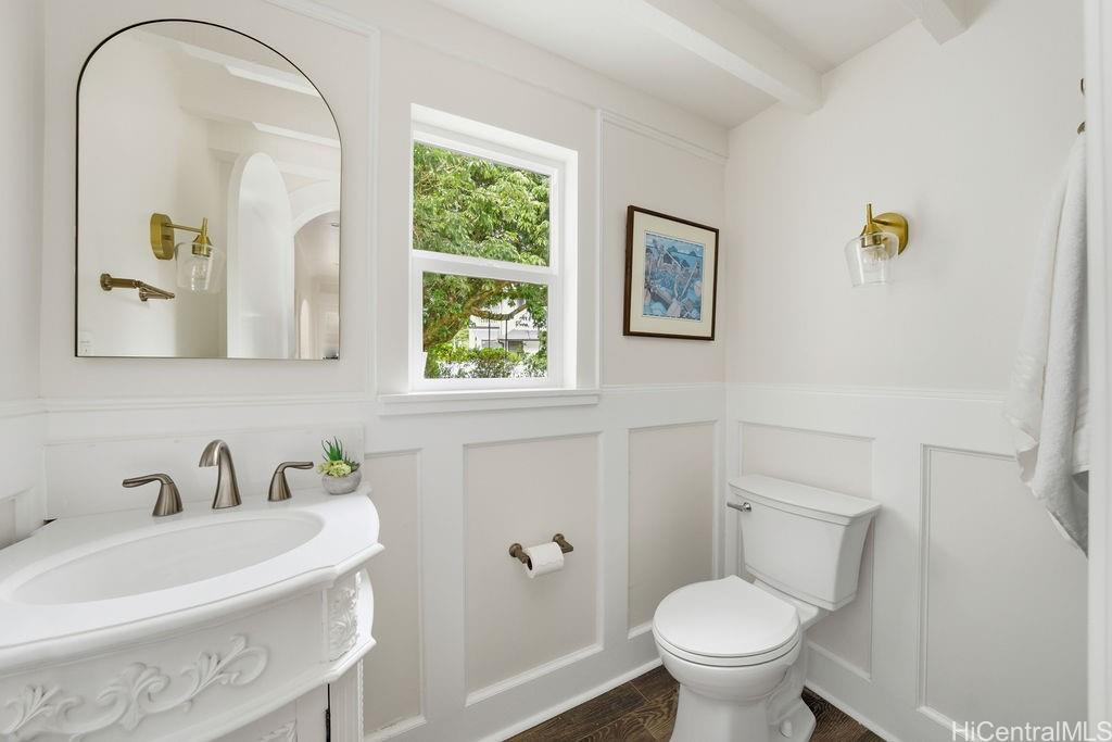 3198 Alika Avenue Honolulu, HI 96817 - Photo 10 of 25 a bathroom with a toilet sink and mirror