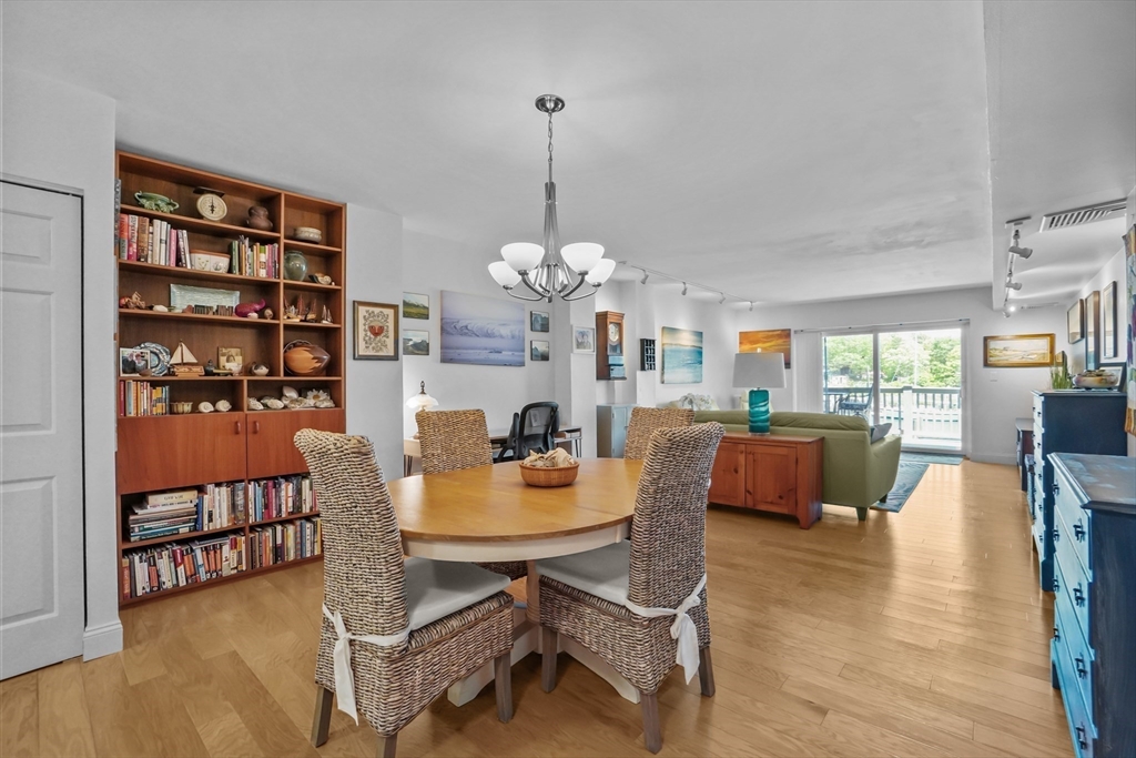 45 Main Street, Unit 112 Wareham, MA 02571 - Photo 6 of 30 a dining room with furniture a rug and wooden floor