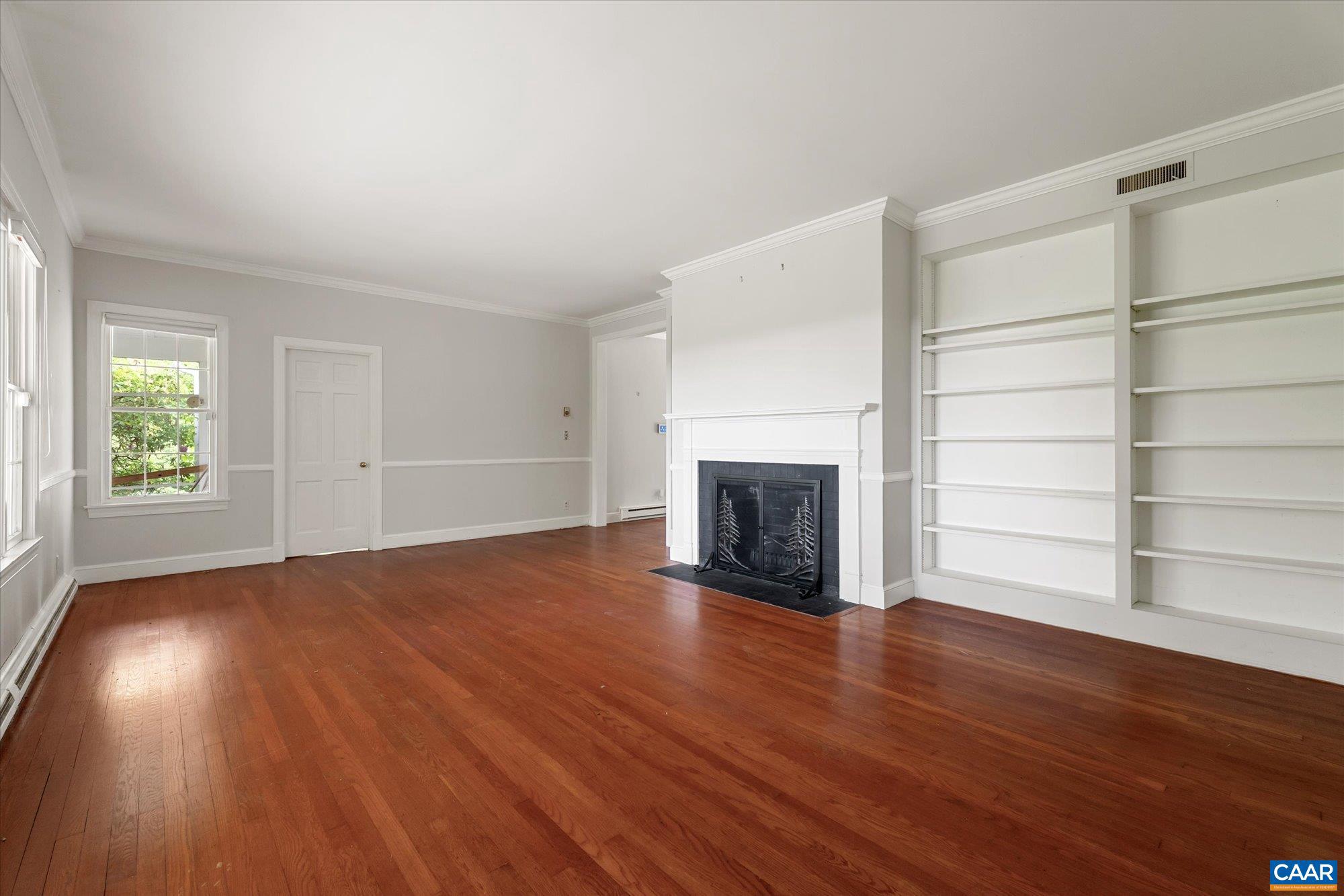 13320 Hackberry Road Orange, VA 22960 - Photo 5 of 47 an empty room with wooden floor fireplace and windows