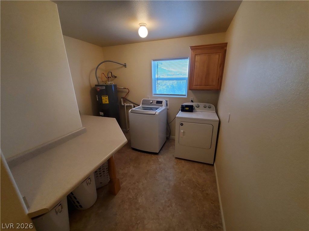 5272 Truman Lane Caliente, NV 89008 - Photo 11 of 43 Laundry room with water heater, washer and clothes dryer, and cabinet space