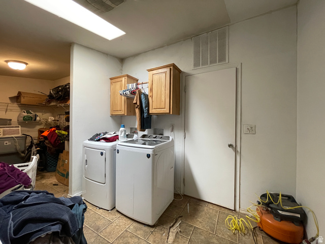 240 Horseshoe Bend Road Vernal, UT 84078 - Photo 22 of 41 Laundry room with cabinet space, washer and clothes dryer, and light stone finish floors