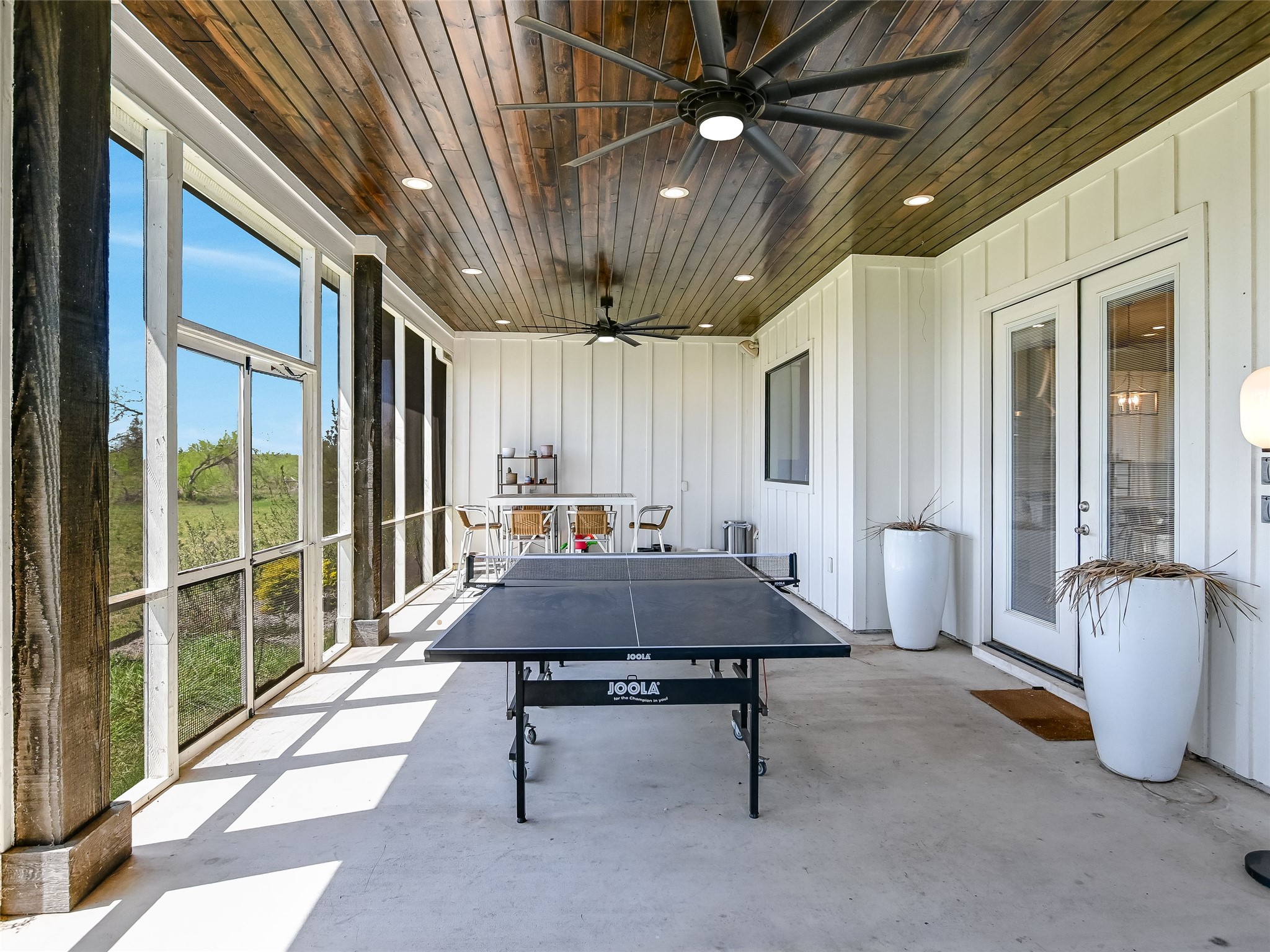 19819 Lockwood Road Manor, TX 78653 - Photo 23 of 29 This extended covered patio doubles as a game zone, party space, or breezy afternoon retreat—proving that fun and function can coexist under one roofline.