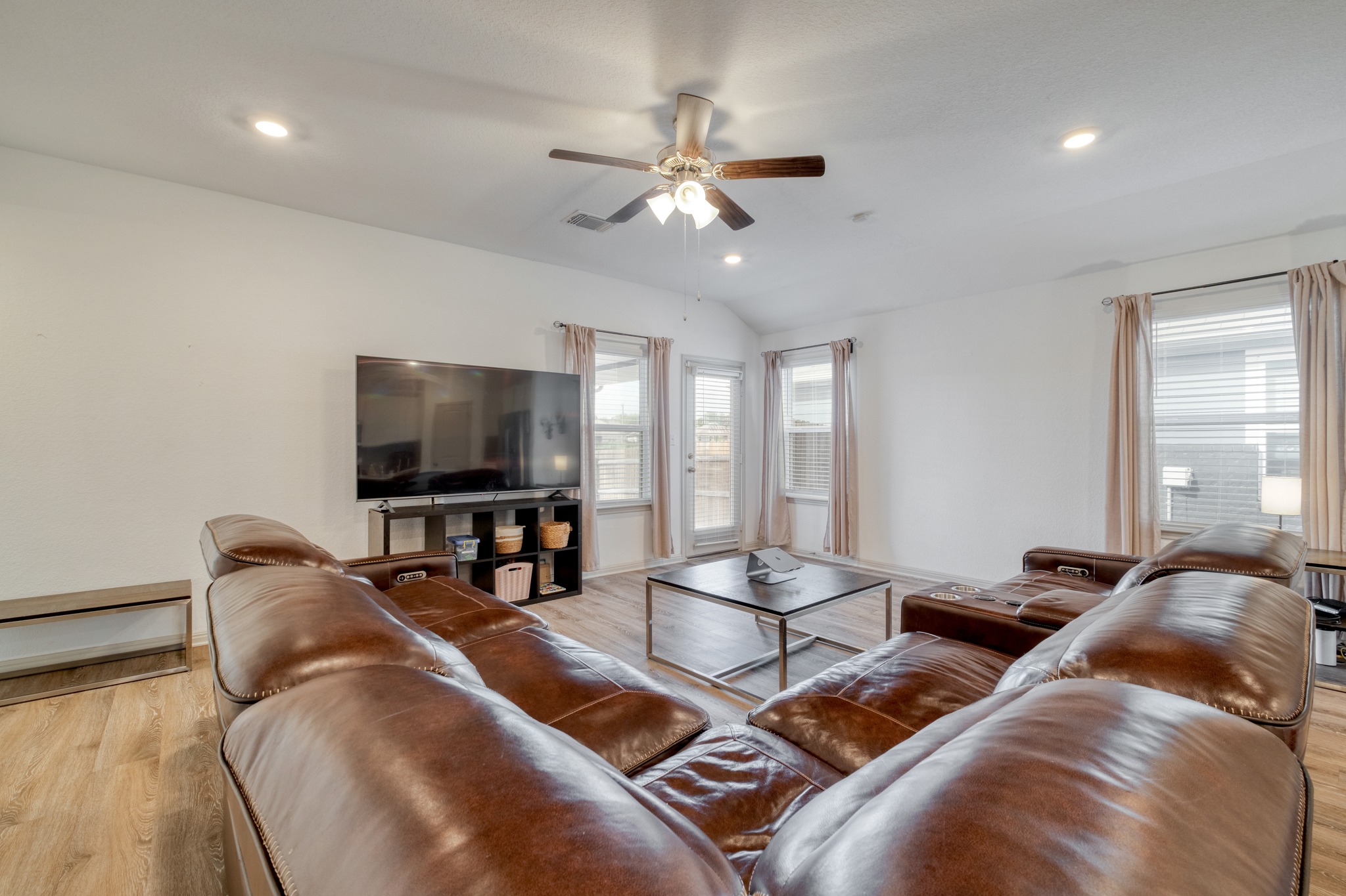 102 Johnson Draw Road Hutto, TX 78634 - Photo 4 of 30 Recessed lighting and warm wood-style flooring anchor this open, airy living space.