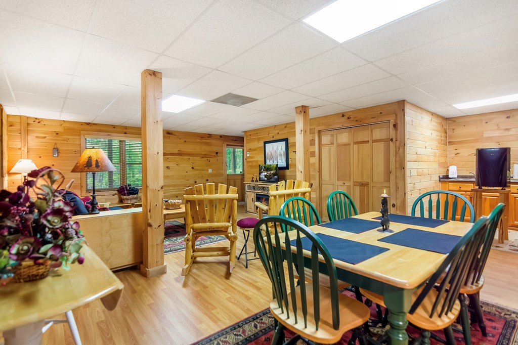 4834 Squirrel Hunting Road Morganton, GA 30560 - Photo 13 of 48 a view of a dining room with furniture one side kitchen view and wooden floor