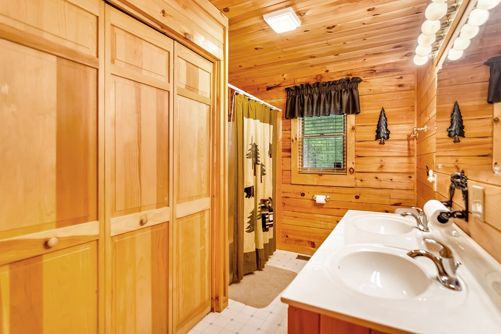 4834 Squirrel Hunting Road Morganton, GA 30560 - Photo 23 of 48 a bathroom with a sink and shower curtain