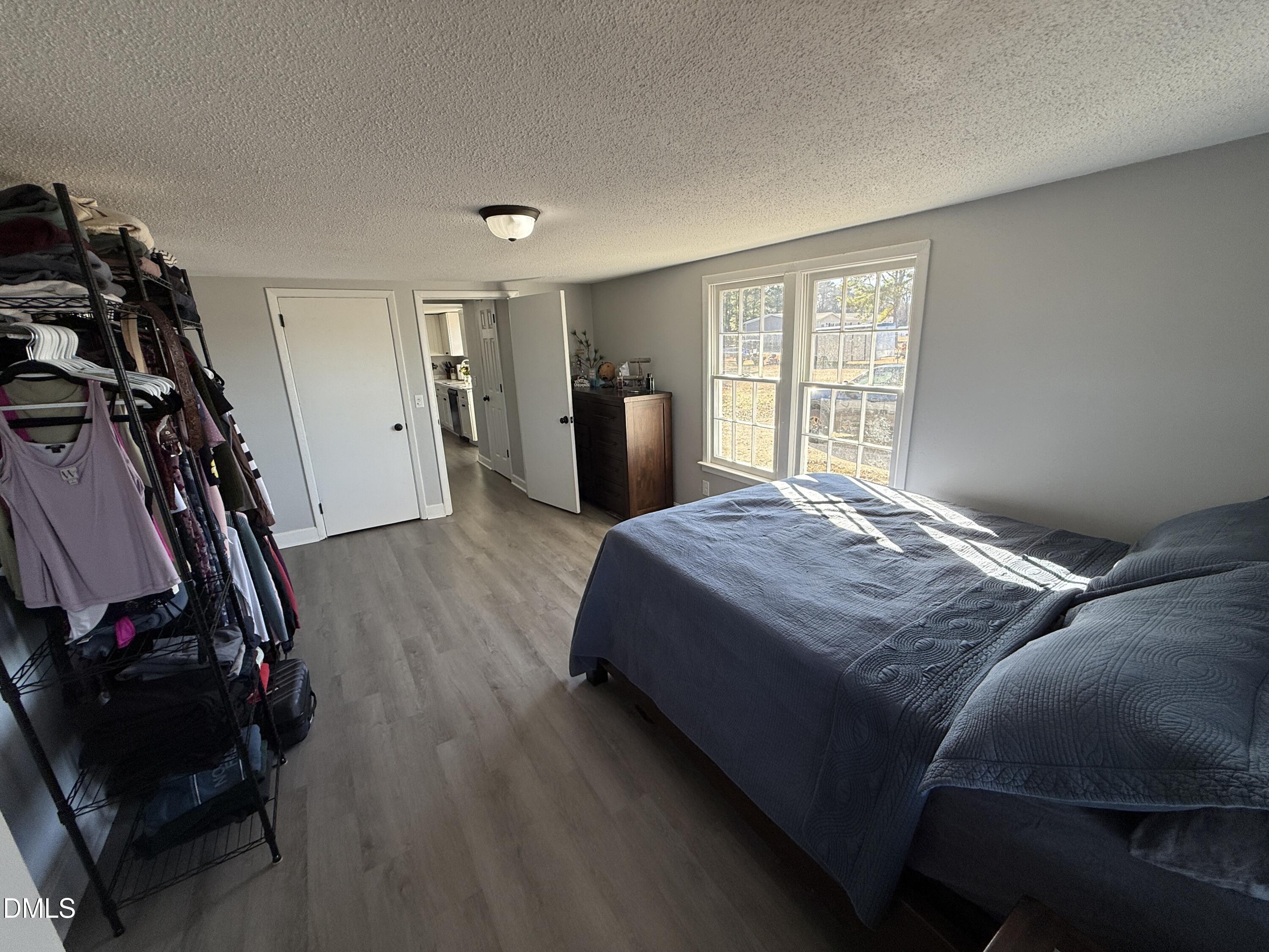 895 Stewart Road Four Oaks, NC 27524 - Photo 16 of 38 a bedroom with a bed closet and a window